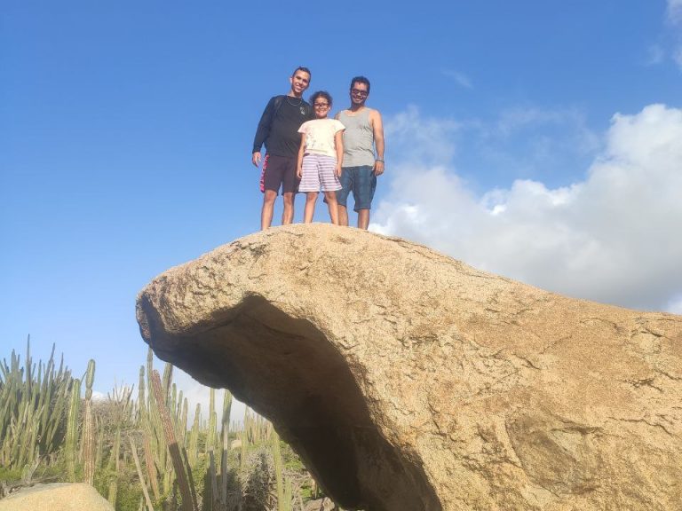 Climbing a hidden rock formation in Aruba